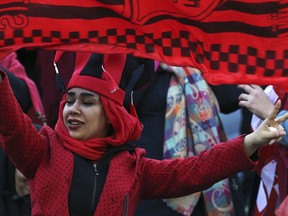 A female Iranian spectator waves a flag of her favorite team Persepolis prior to start their soccer match with Japan's Kashima Antlers during the 2nd leg of the Asian Champions League finals at the Azadi (freedom) stadium in Tehran, Iran, Saturday, Nov. 10, 2018. Authorities allowed a select group of women into Azadi stadium to watch men's soccer match, a rare move in the Islamic theocracy. Since the 1979 Islamic Revolution women have not been allowed to watch men's soccer matches in stadiums, though they have occasionally been allowed to watch volleyball and basketball in stadiums.