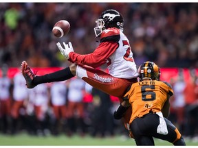 Calgary Stampeders' Bakari Grant, left, fails to make the reception as B.C. Lions' T.J. Lee defends during the first half of a CFL football game in Vancouver, on Saturday November 3, 2018.