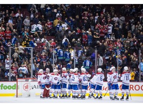 Montreal Canadiens goalie Carey Price, second left, and his teammates celebrate their 3-2 win following third period NHL hockey action against the Vancouver Canucks, in Vancouver on Saturday, Nov. 17, 2018.