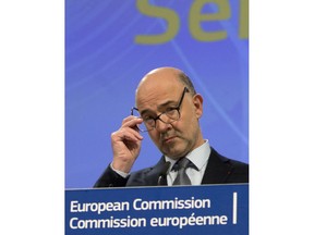 European Commissioner for Economic and Financial Affairs Pierre Moscovici speaks during a media conference at EU headquarters in Brussels, Wednesday, Nov. 21, 2018. A top EU official says Italy's draft budget for next year is in breach of the rulebook underpinning the euro and he is signaling the start of a legal procedure against the country over the spending plan.