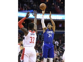 Los Angeles Clippers forward Tobias Harris (34) shoots against Washington Wizards forward Jeff Green (32) during the first half of an NBA basketball game, Tuesday, Nov. 20, 2018, in Washington.