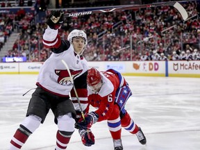 Arizona Coyotes center Clayton Keller and Washington Capitals defenseman Michal Kempny fight for a lose puck in the third period of an NHL hockey game, Sunday, Nov. 11, 2018 in Washington. The Coyotes won 4-1.