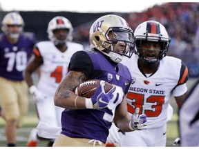 Washington's Myles Gaskin (9) rushes as Oregon State's Jalen Moore (33) pursues in the first half of an NCAA college football game Saturday, Nov. 17, 2018, in Seattle.