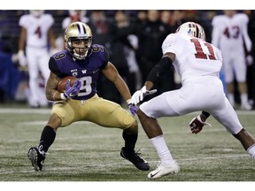 Washington's Myles Gaskin (9) carries as Stanford's Paulson Adebo moves in during the first half of an NCAA college football game Saturday, Nov. 3, 2018, in Seattle.