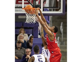 Western Kentucky's Charles Bassey dunks against Washington during the first half of an NCAA college basketball game Tuesday, Nov. 6, 2018, in Seattle.