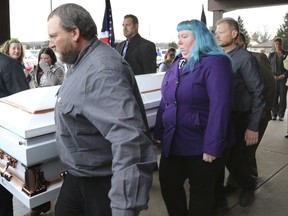 Judy Schneider of Chippewa Falls, the grandmother of Haylee Hickle and mother of Sara Schneider clutches a bear as the casket, holding them both is carried out of Chippewa Valley Bible Church after their funeral in Chippewa Falls, Wis., on Thursday, Nov. 8, 2018. The two were killed Saturday, Nov. 3 in a hit-and-run  accident.