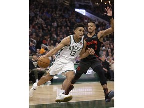 Milwaukee Bucks' Malcolm Brogdon drives against Portland Trail Blazers' CJ McCollum during the first half of an NBA basketball game Wednesday, Nov. 21, 2018, in Milwaukee.