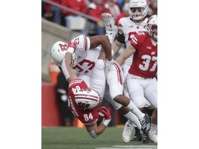 Rutgers's Kiy Hester stops Wisconsin's Jake Ferguson after a catch during the first half of an NCAA college football game Saturday, Nov. 3, 2018, in Madison, Wis.
