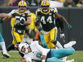 Miami Dolphins quarterback Brock Osweiler fumbles the ball during the first half of an NFL football game against the Green Bay Packers Sunday, Nov. 11, 2018, in Green Bay, Wis.
