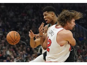 Milwaukee Bucks' Giannis Antetokounmpo is fouled by Chicago Bulls' Robin Lopez during the first half of an NBA basketball game Friday, Nov. 16, 2018, in Milwaukee.