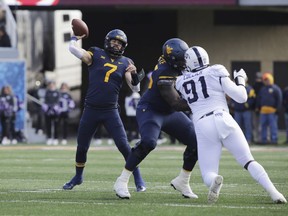 West Virginia quarterback Will Grier (7) attempts a pass during the first half of an NCAA college football game against TCU, Saturday, Nov. 10, 2018, in Morgantown, W.Va.