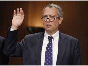 FILE - In this Sept. 20, 2017, file photo, Thomas  Farr is sworn in during a Senate Judiciary Committee hearing on his nomination to be a District Judge on the United States District Court for the Eastern District of North Carolina, on Capitol Hill in Washington.