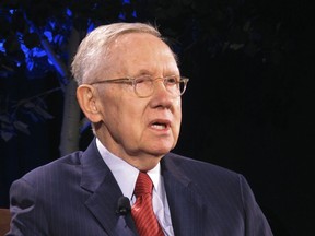 FILE - In this April 3, 2018, file photo, former Senate Majority Leader Harry Reid speaks during a joint appearance with former U.S. Secretary of State John Kerry during a lecture series at the University of Nevada, Reno. He may no longer lead Democrats in the U.S. Senate, but the political machine Reid built to turn Nevada blue is still humming along. Democrats romped up and down the state, ousting Republican Sen. Dean Heller and taking the governorship, lieutenant governor, attorney general and treasurer posts while expanding their state legislative control to supermajorities.