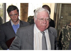 FILE - In this Oct. 7, 2008, file photo, Jerome Corsi, right, arrives at the immigration department in Nairobi, Kenya. Corsi, a conservative writer and associate of President Donald Trump confidant Roger Stone says he is in plea talks with special counsel Robert Mueller's team. Jerome Corsi told The Associated Press on Friday, Nov. 23, 2018, that he has been negotiating a potential plea but declined to comment further.