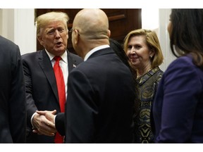 In this Nov. 13, 2018, photo, Deputy National Security Adviser Mira Ricardel, right, watches as President Donald Trump arrives for a Diwali ceremonial lighting of the Diya in the Roosevelt Room of the White House, Tuesday, Nov. 13, 2018, in Washington. Ricardel is leaving the White House, one day after first lady Melania Trump's office issued an extraordinary statement calling for her dismissal.