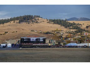 In this Oct. 18, 2018, file photo, a campaign rally is seen from the motorcade, with President Donald Trump aboard, at Minuteman Aviation Hangar in Missoula, Mont. Trump is in the final stretch of a 44-city blitz for the midterm elections, but the America he's glimpsed from the airport arrivals and his armored limousine is hardly a reflection of the nation as a whole.