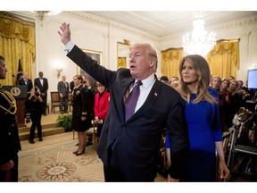 In this Nov. 16, 2018, photo, first lady Melania Trump walks with President Donald Trump as they leave a Medal of Freedom ceremony in the East Room of the White House in Washington, Friday, Nov. 16, 2018.