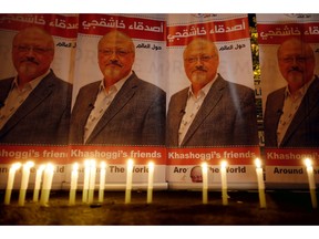 FILE - In this Oct. 25, 2018, file photo, candles, lit by activists, protesting the killing of Saudi journalist Jamal Khashoggi, are placed outside Saudi Arabia's consulate, in Istanbul, during a candlelight vigil. President Donald Trump is facing mounting pressure to sternly rebuke Saudi Arabia over the death of Khashoggi. So far, Trump is resisting calls to harshly reprimand the close U.S. ally.