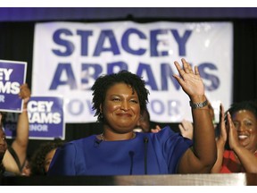 FILE- In this May 22, 2018, file photo Democratic candidate for Georgia Gov. Stacey Abrams waves at a campaign event in Atlanta. Over the course of a year, Stacey Abrams has transformed from a technocratic leader in the Georgia legislature into a nationally known symbol of the Democratic Party's future.