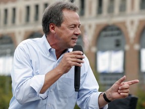 FILE - In this Aug. 16, 2018, file photo, Montana Gov. Steve Bullock speaks at the Des Moines Register Soapbox during a visit to the Iowa State Fair in Des Moines, Iowa. Motivated by an urgency to unseat President Donald Trump and the prospect of a historically large primary field, Democrats see little incentive to delay or downplay their 2020 presidential hopes.