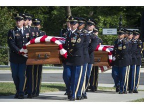 In this Sept. 6, 2018 photo, the 3rd Infantry Regiment, also known as the Old Guard, carry the remains of two unknown Civil War Union soldiers to their grave at Arlington National Cemetery in Arlington, Va. The U.S. Army is being criticized for reburying the remains of two recently discovered Civil War soldiers without conducting DNA testing. The soldiers were found at Manassas National Battlefield, among severed limbs in what researchers believe was a surgeon's pit. Army officials said DNA testing was unjustified and reburied them as unknown soldiers at Arlington National Cemetery.
