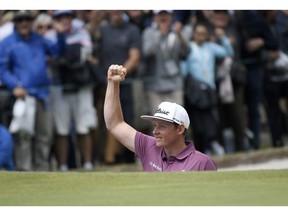 Australia's Cameron Smith reacts after hitting out of a bunker during the World Cup of Golf in Melbourne, Australia, Sunday, Nov. 25, 2018.