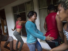 In this Nov. 1, 2018 photo, members of the LGBTQ community who are part of the Central American migrants caravan hoping to reach the U.S. border, break into a celebratory dance outside an abandoned hotel after arriving in Donaji, Mexico. The 50 or so LGBTQ migrants traveling together, most of them in their 20s but some as young as 17 or as old as 60, say they banded together for safety in numbers, a sort of caravan within the caravan.