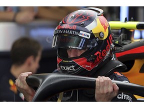 Red Bull driver Max Verstappen of the Netherlands gets out of his car cockpit during the first free practice at the Yas Marina racetrack in Abu Dhabi, United Arab Emirates, Friday Nov. 23, 2018. The Emirates Formula One Grand Prix will take place on Sunday.