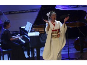 Japanese pianist Kaoru Imahigashi plays the piano while opera singer Fujiko Hirai, right, perform during a concert to mark the debut of Gaza's only grand piano after it was rescued from conflict, at a theater nestled in the Palestinian Red Crescent Society's building in Gaza City, Sunday, Nov. 25, 2018. The only grand piano in the Gaza Strip is debuting to the public for the first time in over a decade after its restoration.