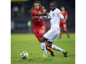 FILE - In this file photo taken on , Wednesday, Nov. 14, 2018, Switzerland's Kevin Mbabu, left, vies for the ball against Qatar's Abdelkarim Hassan during an international friendly soccer match between Switzerland and Qatar at the Cornaredo stadium in Lugano, Switzerland. Exactly four years from now (Nov. 21), Qatar will be kicking off the World Cup in its own country, in front of 80,000 fans at Lusail Stadium, with around 300 million more watching on television.