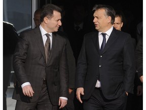 In this picture taken Dec 5, 2013, Macedonian Prime Minister Nikola Gruevski, left, talks to Hungarian Prime Minister Viktor Orban, right, during their meeting in Skopje, Macedonia. Macedonia's fugitive former prime minister Gruevski said Tuesday, Nov. 20, 2018 he has been granted political asylum in Hungary, a week after he fled his country to avoid serving a two-year jail sentence for a corruption conviction.