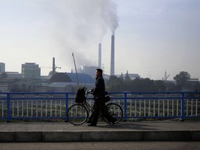 In this Sunday, Oct. 21, 2018 photo, smokes billows from the chimneys of Pyongyang Power Plant in Pyongyang, North Korea. Twenty years after his father almost bargained them away for a pair of nuclear reactors, North Korean leader Kim Jong Un has his nuclear weapons - and a nation still plagued by chronic blackouts. But years of sanctions have spurred the North to cobble together a creative smorgasbord of alternative resources, some off the official grid and some flat-out illegal.
