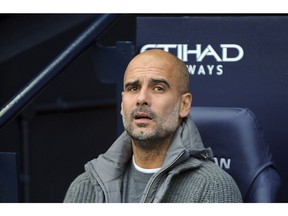 Manchester City manager Josep Guardiola looks out from the bench prior the English Premier League soccer match between Manchester City and Southampton at Etihad stadium in Manchester, England, Sunday, Nov. 4, 2018.