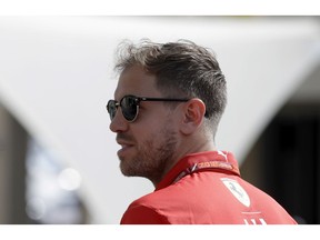 Ferrari driver Sebastian Vettel of Germany arrives ahead of the third free practice at the Yas Marina racetrack in Abu Dhabi, United Arab Emirates, Saturday, Nov. 24, 2018. The Emirates Formula One Grand Prix will take place on Sunday.