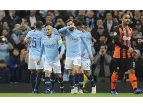 Manchester City players celebrate after scoring the opening goal during the Champions League Group F soccer match between Manchester City and Shakhtar Donetsk at Etihad stadium in Manchester, England, Wednesday, Nov. 7, 2018.