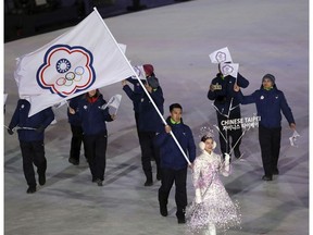 FILE - In this file photo taken Friday, Feb. 9, 2018, Taiwanese athlete Lien Te-An carries the Chinese Taipei flag representing Taiwan during the opening ceremony of the 2018 Winter Olympics in Pyeongchang, South Korea. Taiwan will vote on a referendum this month asking if the self-ruled island should compete as "Taiwan" instead of the present "Chinese Taipei." This would include the 2020 Olympics in Tokyo. The controversial referendum has angered China, which sees Taiwan as a breakaway province.