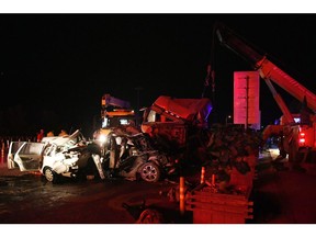 In this Saturday, Nov. 3, 2018, photo released by China's Xinhua News Agency, the aftermath of a highway accident is seen in Lanzhou in northwestern China's Gansu province. Authorities say more than a dozen people have been killed in a highway pile-up on Saturday night after a heavy truck lost control and crashed into a line of vehicles waiting at a toll station.