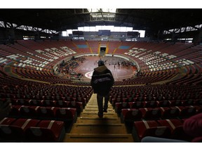 In this Nov. 12, 2018 photo, a Central American migrant, part of the caravan hoping to reach the U.S. border, arrives at the Benito Juarez Auditorium that is being as a migrant shelter, in Guadalajara, Mexico. Several thousand Central American migrants marked a month on the road Monday as they hitched rides toward the western Mexico city of Guadalajara.