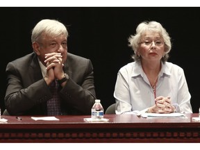 FILE - In this  Aug. 7, 2018 file photo, Mexico's President-elect Andres Manuel Lopez Obrador and incoming Interior Secretary Olga Sanchez attend a meeting on security and national reconciliation, in Ciudad Juarez, Mexico. Mexico's incoming government says it does not plan to assume the role of "safe third country" for migrants seeking asylum in the U.S. after Lopez Obrador is sworn in as president on Dec. 1.