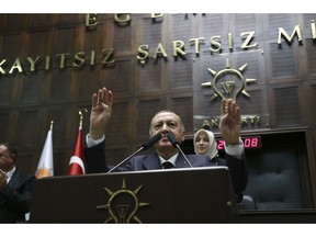 Turkey's President Recep Tayyip Erdogan gestures as he takes the stand to deliver a speech to MPs of his ruling Justice and Development Party (AKP) at the parliament in Ankara, Turkey, Tuesday, Nov. 6, 2018.