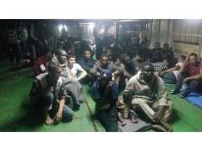 FILE - In this fike photo provided Nov. 14, 2018, migrants on board the container ship Nivin are refusing to disembark in Misrata, Libya. Libyan authorities have forcibly removed dozens of migrants who had barricaded themselves in a container ship in the port city of Misrata for the past 10 days after being picked up at sea.(AP Photo, File)