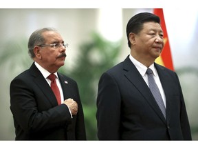 The Dominican Republic President Danilo Medina, left, and Chinese President Xi Jinping stand together during a welcome ceremony at the Great Hall of the People in Beijing, Friday, Nov. 2, 2018. China is rolling out the red carpet for the second time this week for a Latin American leader whose country recently switched its allegiance from Taipei to Beijing.