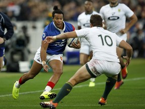 France's Teddy Thomas runs at South Africa's Handre Pollard during their rugby union international at the Stade de France in Paris, France, Saturday, Nov. 10, 2018.