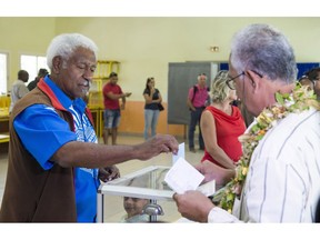Roch Wamytan, one of the former leaders of the independentist party, Union Caledonienne, casts his vote at a poling station in Le Mont-Dore, New Caledonia during an independence referendum, Sunday, Nov. 4, 2018. Voters in New Caledonia are deciding whether the French territory in the South Pacific should break free from the European country that claimed it in the mid-19th century.