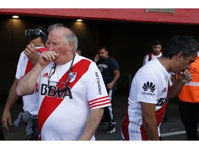 River Plate fans affected by pepper gas enter to Antonio Vespucio Liberti stadium prior to the final soccer match of the Copa Libertadores in Buenos Aires, Argentina, Saturday, Nov. 24, 2018.