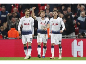 Tottenham forward Harry Kane, center, celebrates with teammates his sides second goal in front of fans during the Champions League Group B soccer match between Tottenham Hotspur and PSV Eindhoven at Wembley Stadium in London, England, Tuesday, Nov. 6, 2018.
