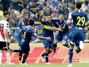 Ramón Abila of Argentina's Boca Juniors celebrates with teammates scoring his side's first goal against Argentina's River Plate during a Copa Libertadores first leg final match in Buenos AIres, Argentina, Sunday, Nov. 11, 2018.