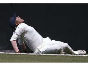 India's Prithvi Shaw grimaces as he falls to the ground after rolling his ankle while attempting a catch during their tour cricket match against Cricket Australia XI in Sydney, Friday, Nov. 30, 2018.
