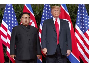 FILE - In this June 12, 2018, file photo, U.S. President Donald Trump, right, stands with North Korean leader Kim Jong Un on Sentosa Island in Singapore. North Korea and the United States are trying to revive stalled diplomacy meant to rid the North of its nuclear weapons. There was much talk of the possibility of success following a meeting in June between Trump and Kim, but in the months since there has been little to quiet skeptics who believe the North will never give up weapons it has described as necessary to counter a hostile Washington.