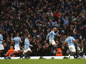 Manchester City's David Silva, second right, celebrates after scoring his side's opening goal during the English Premier League soccer match between Manchester City and Manchester United at the Etihad stadium in Manchester, England, Sunday, Nov. 11, 2018.